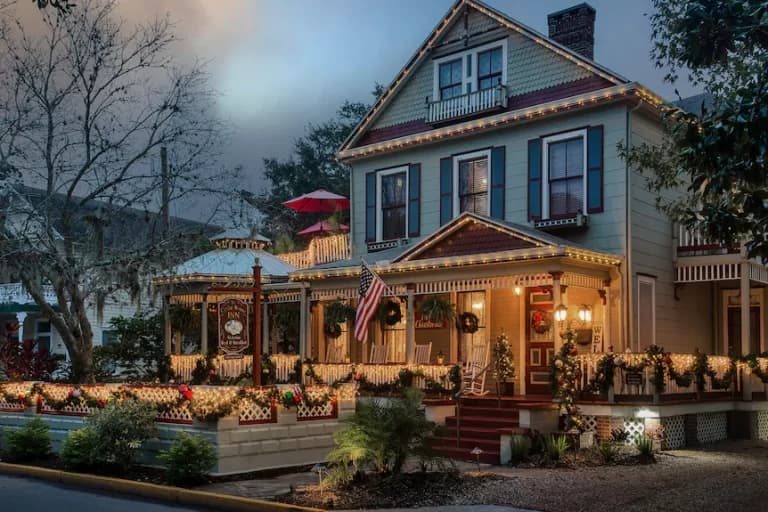A beautifully decorated Victorian house adorned with holiday lights and festive wreaths. A beautifully decorated Victorian house adorned with holiday lights and festive wreaths.