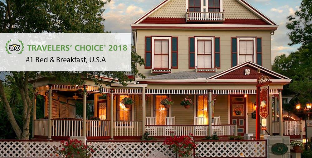 A charming bed and breakfast featuring a welcoming porch and lush greenery, recognized as the #1 in the U.S. in 2018.